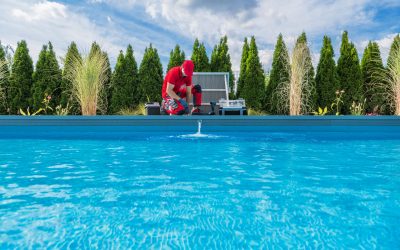 Professional Caucasian Swimming Pools Technician in His 40s Performing Seasonal Maintenance. Outdoor Residential Backyard Pool.